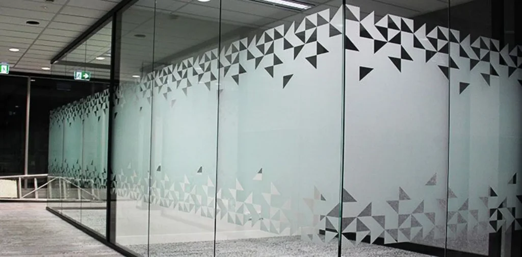 Glass office wall with frosted film and decorative triangle pattern
